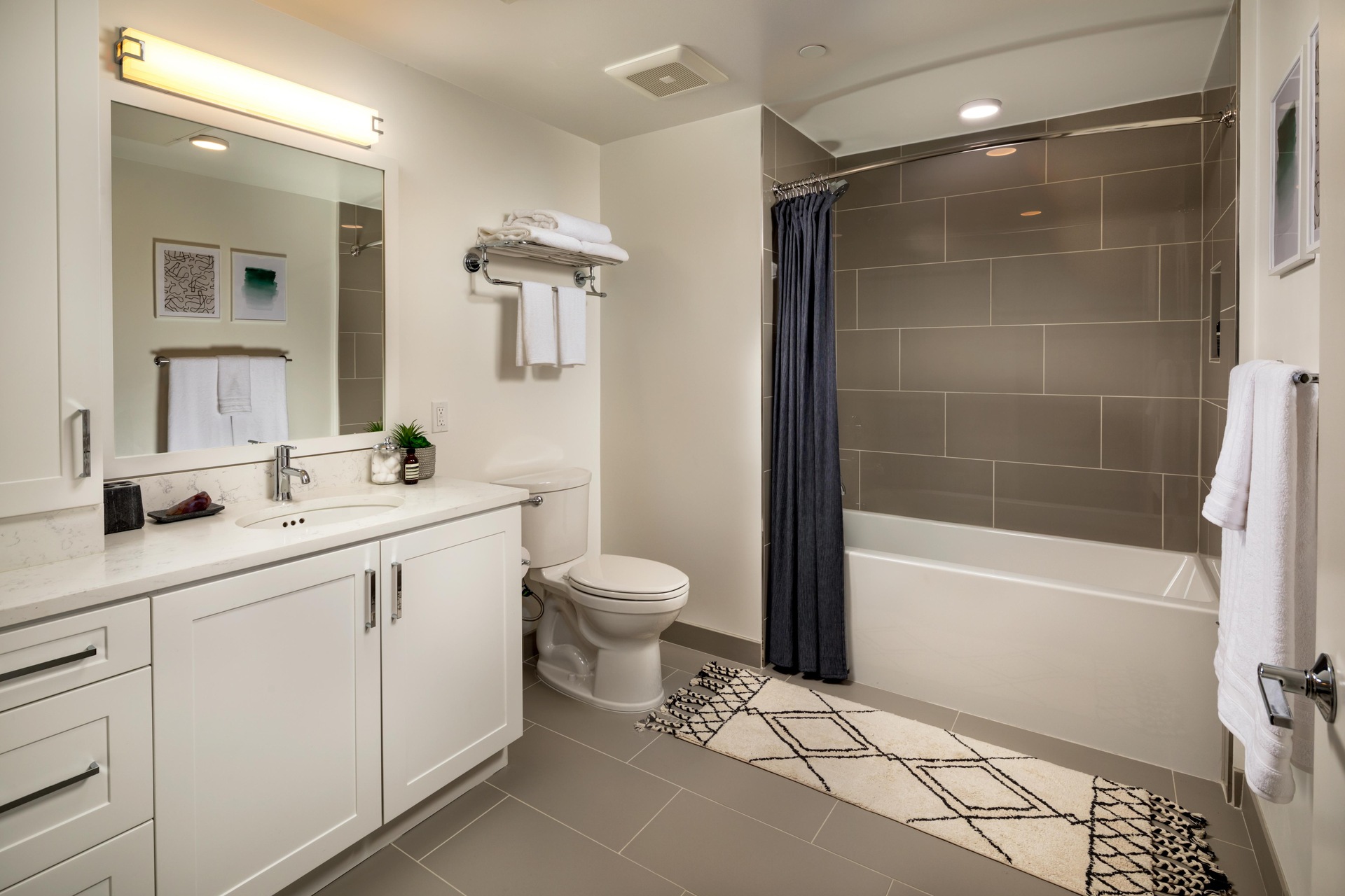 Bathroom with quartz countertops and porcelain tile